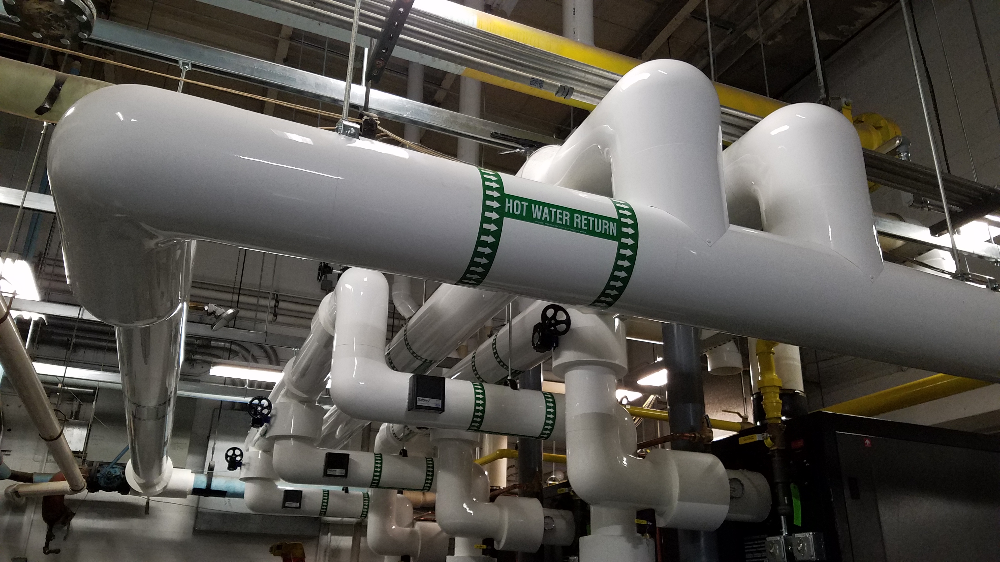 PVC-jacketed insulated piping installed by Ravenshade